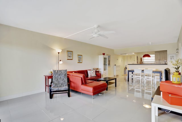 living room featuring ceiling fan and light tile patterned floors