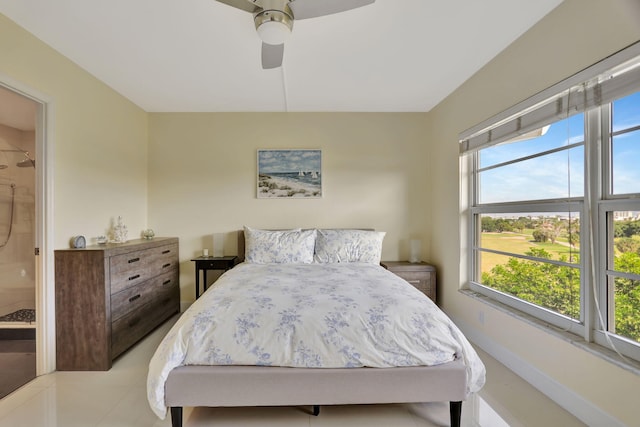 bedroom with ceiling fan, connected bathroom, and multiple windows