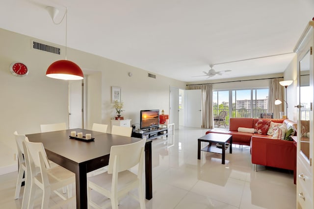 dining space with ceiling fan and light tile patterned flooring