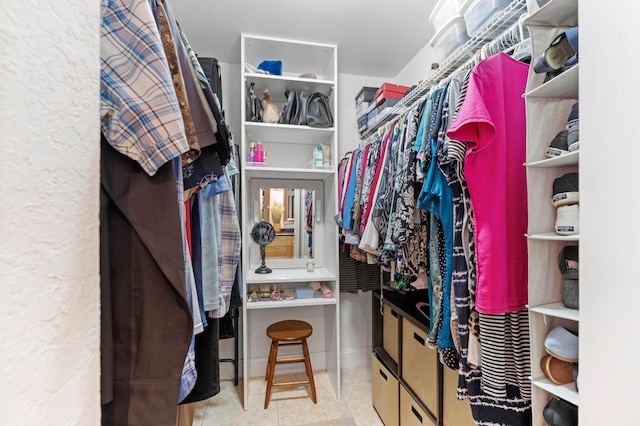 walk in closet with light tile patterned floors