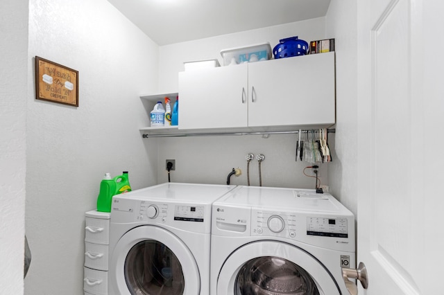 laundry area with cabinets and washing machine and clothes dryer