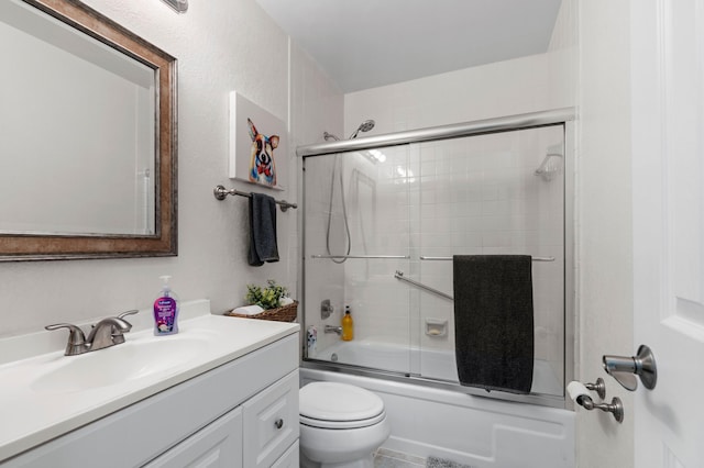 full bathroom with vanity, toilet, and shower / bath combination with glass door