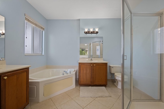 full bathroom with tile patterned floors, vanity, shower with separate bathtub, and toilet