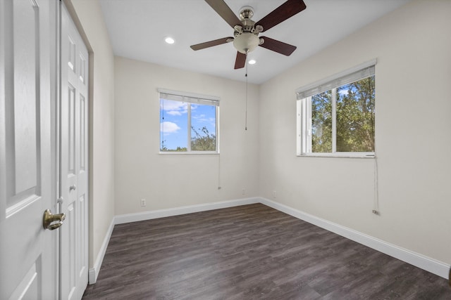 unfurnished bedroom featuring multiple windows, ceiling fan, and dark hardwood / wood-style floors