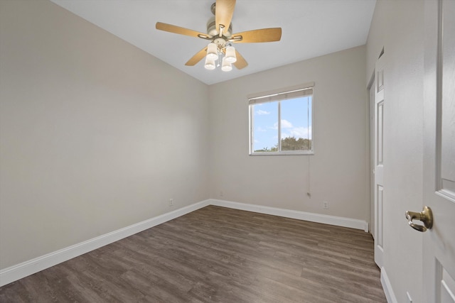 spare room with dark hardwood / wood-style floors and ceiling fan