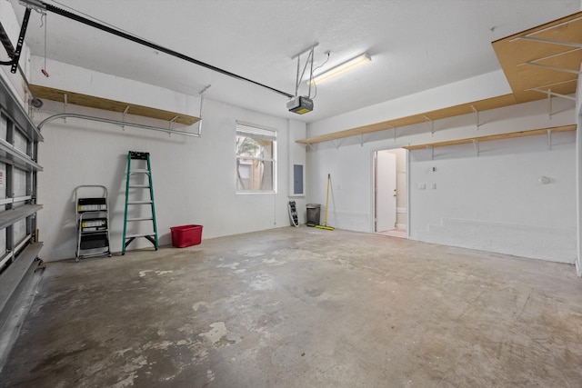 garage featuring electric panel and a garage door opener