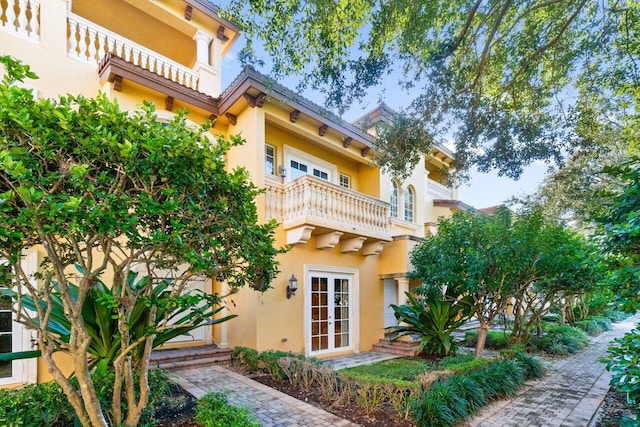 back of house featuring french doors and a balcony