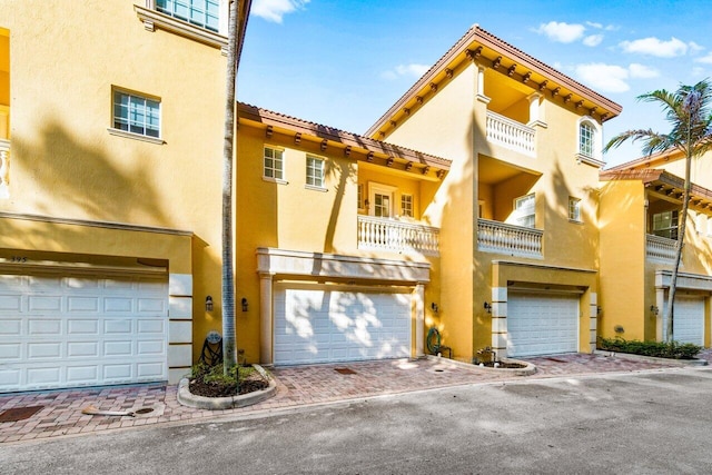 view of front facade with a balcony and a garage