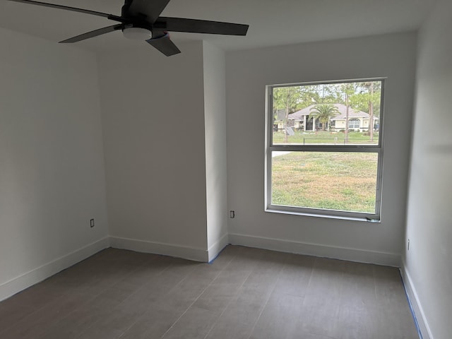 unfurnished room featuring ceiling fan, a wealth of natural light, and light hardwood / wood-style flooring