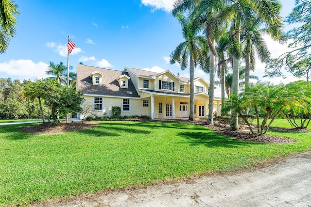 view of front facade with covered porch and a front yard