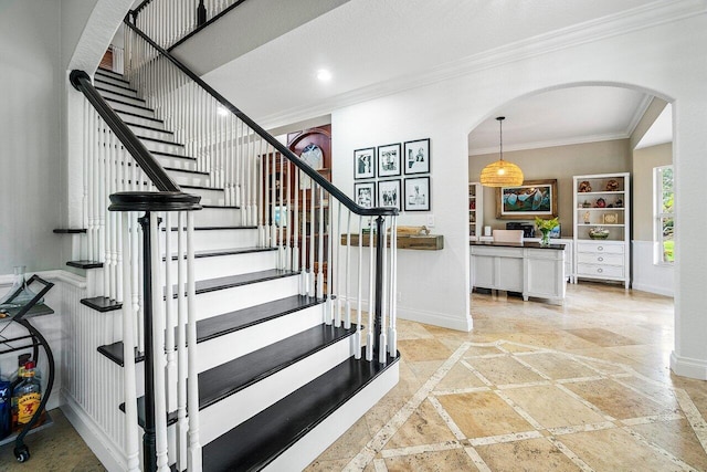 stairway featuring ornamental molding