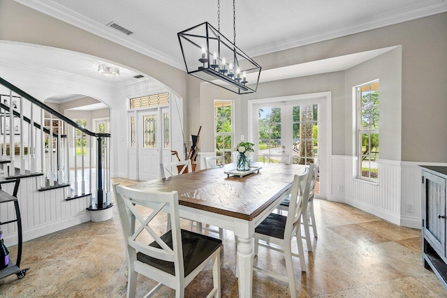 dining room featuring crown molding, french doors, and a textured ceiling