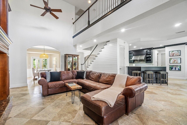 living room featuring high vaulted ceiling and ceiling fan