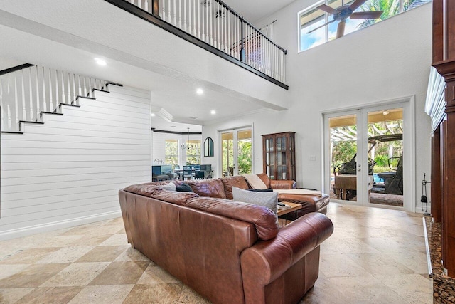 living room with wood walls and a high ceiling