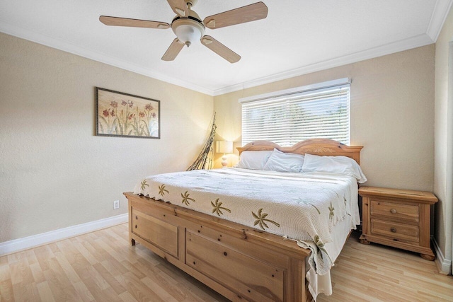 bedroom featuring light hardwood / wood-style flooring, ceiling fan, and crown molding