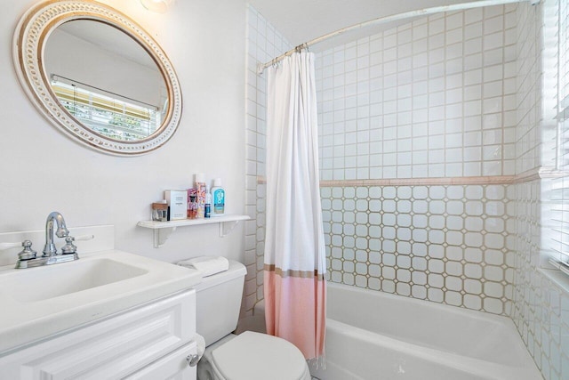 full bathroom featuring shower / bath combo, vanity, and toilet