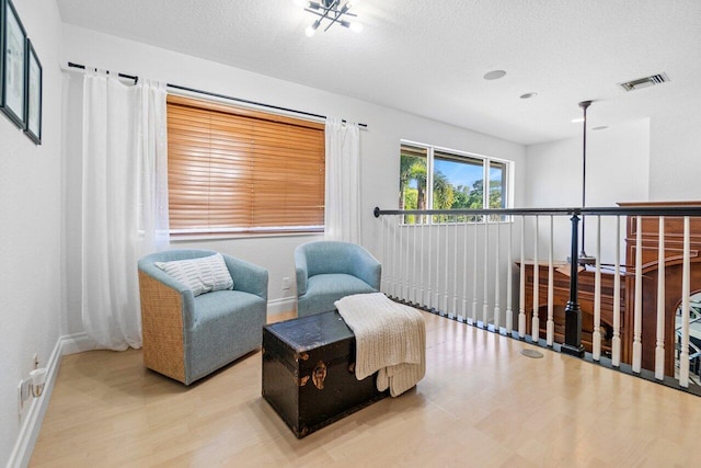 living area featuring a textured ceiling