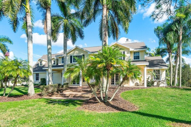 view of front of home featuring a front lawn and french doors