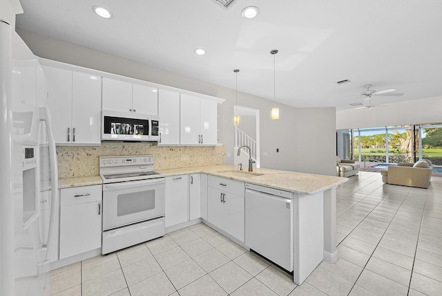 kitchen featuring white cabinetry, sink, hanging light fixtures, kitchen peninsula, and white appliances