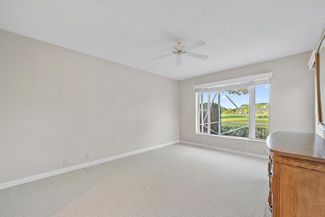 interior space featuring light carpet and ceiling fan