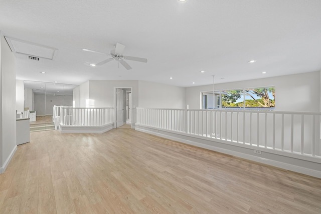 spare room with ceiling fan and light hardwood / wood-style floors