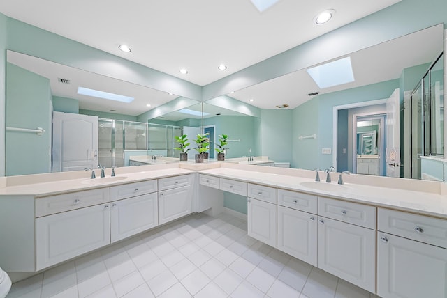 bathroom with an enclosed shower, a skylight, toilet, and vanity