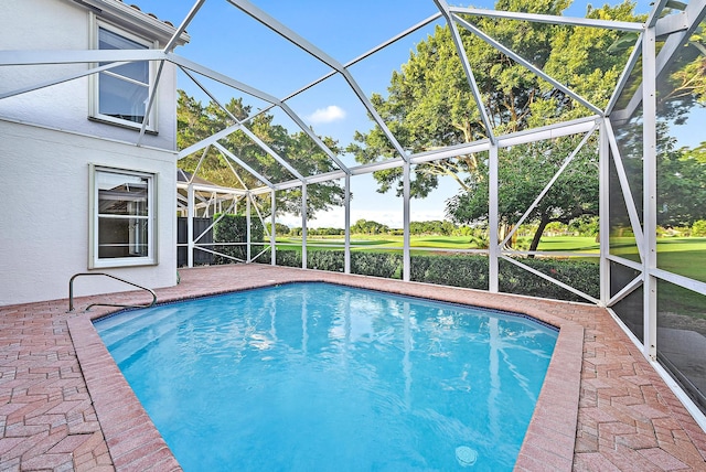 view of swimming pool featuring a patio area and a lanai