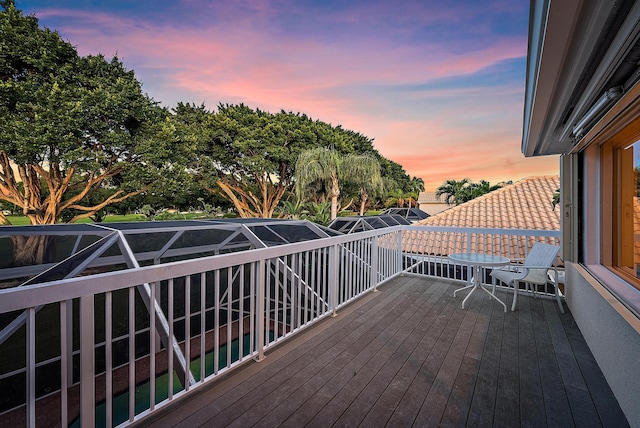 deck at dusk with glass enclosure