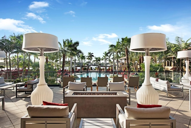 view of patio with an outdoor fire pit and a community pool