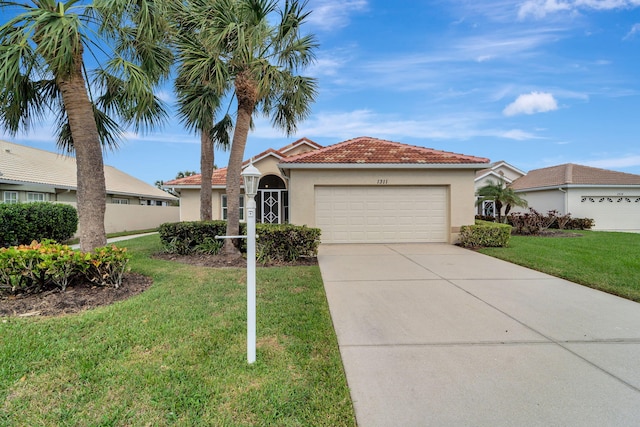 view of front of home featuring a front yard and a garage