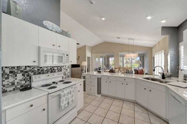 kitchen with white cabinetry, white appliances, sink, and vaulted ceiling