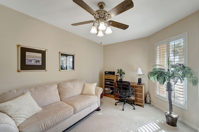 carpeted office featuring ceiling fan