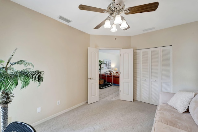 sitting room featuring ceiling fan and light carpet