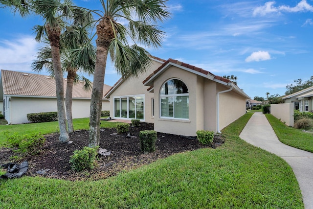 view of side of property with a yard