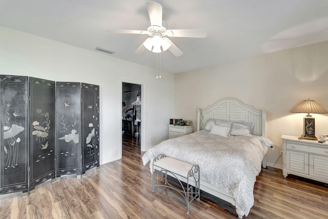 bedroom featuring hardwood / wood-style floors, ceiling fan, a spacious closet, and a closet