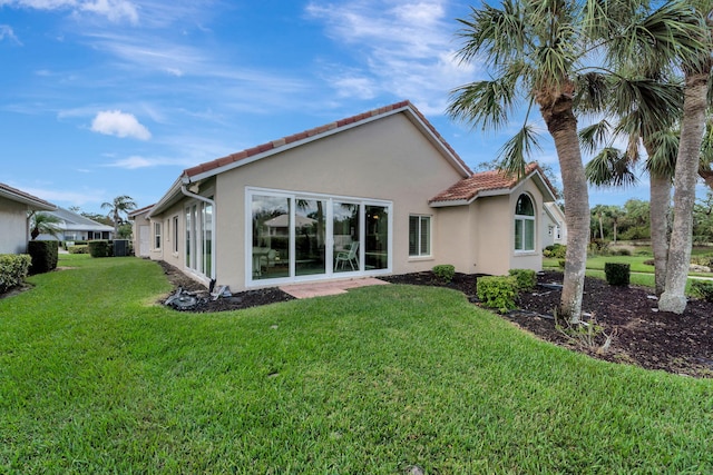 rear view of property featuring a yard