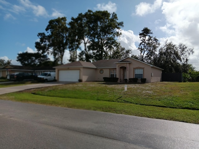 ranch-style house featuring a garage and a front lawn