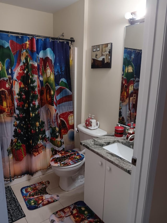 bathroom with tile patterned floors, curtained shower, vanity, and toilet