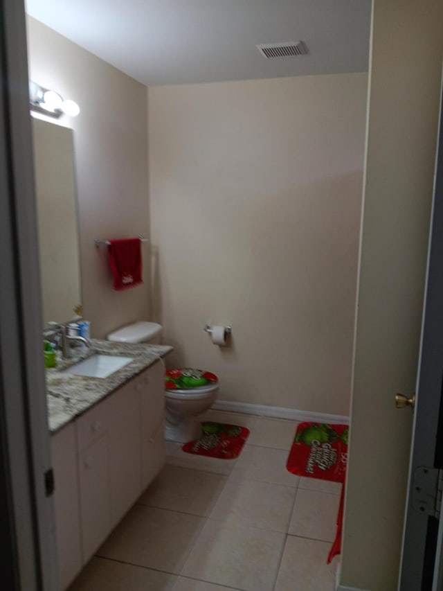 bathroom with tile patterned floors, vanity, and toilet