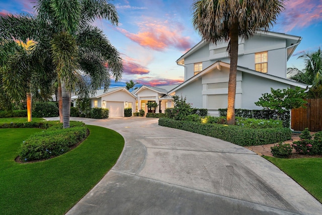 view of front of property with a lawn and a garage