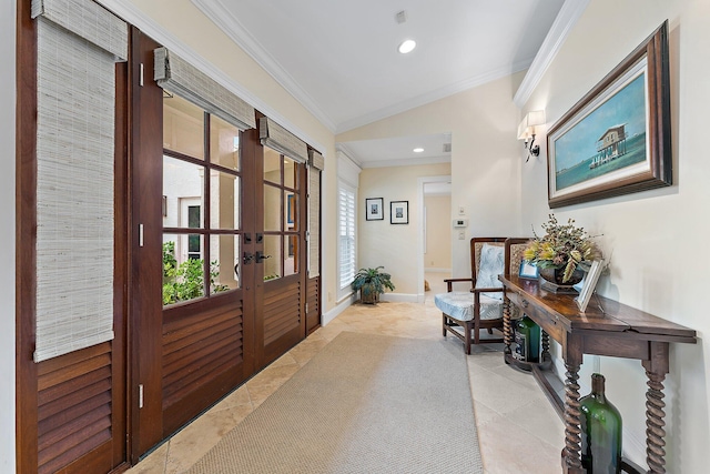 hall with french doors, lofted ceiling, light tile patterned floors, and ornamental molding