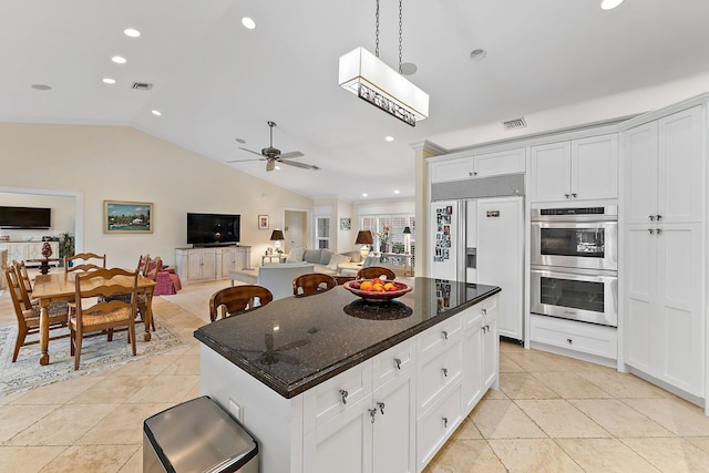 kitchen featuring lofted ceiling, paneled built in fridge, ceiling fan, double oven, and white cabinetry