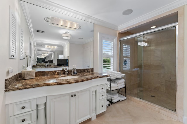 bathroom with tile patterned flooring, vanity, an enclosed shower, and ornamental molding