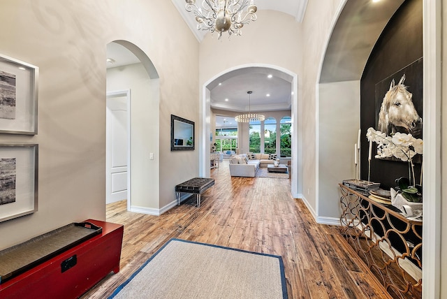 7190 Tradition Cove Ln E, West Palm Beach, FL 33412 - foyer with arched walkways, a chandelier, and hardwood / wood-style floors