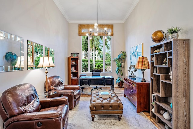 sitting room with a towering ceiling, light hardwood / wood-style floors, crown molding, and a notable chandelier