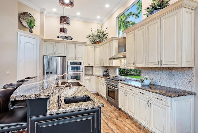 7190 Tradition Cove Ln E, West Palm Beach, FL 33412 - kitchen featuring appliances with stainless steel finishes, wall chimney exhaust hood, crown molding, dark stone countertops, and a kitchen bar