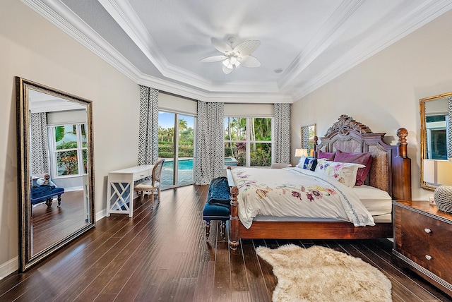 bedroom with access to exterior, ceiling fan, dark wood-type flooring, a raised ceiling, and ornamental molding