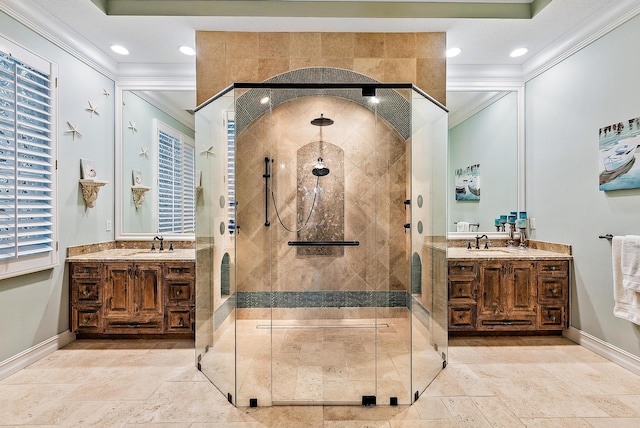 bathroom featuring vanity, a shower with shower door, and crown molding