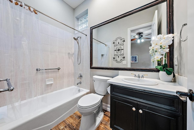 full bathroom with vanity, ceiling fan, hardwood / wood-style flooring, toilet, and tiled shower / bath