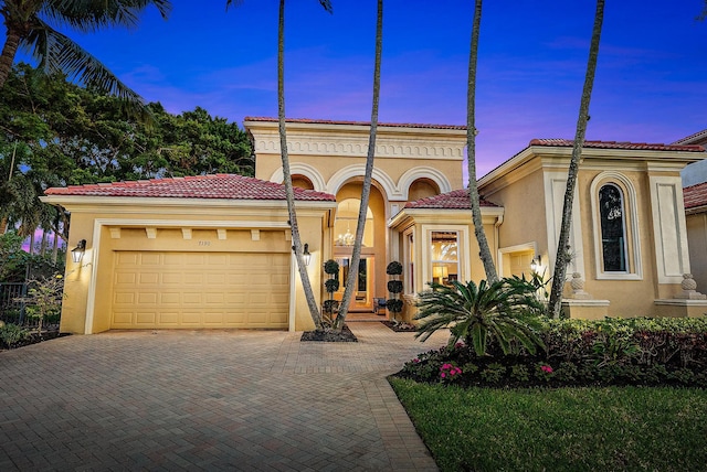 7190 Tradition Cove Ln E, West Palm Beach, FL 33412 - mediterranean / spanish-style house featuring stucco siding, decorative driveway, a garage, and a tiled roof